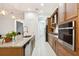 Modern kitchen with stainless steel appliances, granite countertops, and ample cabinet space at 9132 Bernini Pl, Sarasota, FL 34240