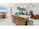 Open-concept kitchen featuring granite counters, stainless appliances, and a connected living space at 9132 Bernini Pl, Sarasota, FL 34240