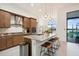Modern kitchen featuring stainless steel appliances, granite countertops, and a scenic view at 9132 Bernini Pl, Sarasota, FL 34240