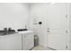 Well-equipped laundry room with modern washer and dryer units and ample space for sorting and folding at 9132 Bernini Pl, Sarasota, FL 34240