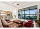 Spacious living area with a modern kitchen, lake views, and comfortable seating at 9132 Bernini Pl, Sarasota, FL 34240