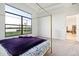 Spacious main bedroom featuring a large window view and a canopy bed with luxury linens at 9132 Bernini Pl, Sarasota, FL 34240