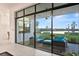 Relaxing outdoor patio with plush seating and beautiful views of the lake at 9132 Bernini Pl, Sarasota, FL 34240