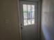 Interior view of back door with decorative glass and backyard view at 11608 Zimmerman Rd, Port Richey, FL 34668