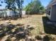Spacious backyard featuring a partial fence and shade trees, ready for outdoor activities at 11608 Zimmerman Rd, Port Richey, FL 34668