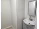 Small bath featuring modern vanity with a decorative mirror and tiled floors at 11608 Zimmerman Rd, Port Richey, FL 34668