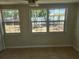 Bright bedroom boasts natural light, tile flooring, a ceiling fan and a view to the backyard at 11608 Zimmerman Rd, Port Richey, FL 34668