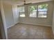 Inviting bedroom features tile flooring, a ceiling fan, and plenty of natural light at 11608 Zimmerman Rd, Port Richey, FL 34668