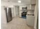 Bright kitchen boasts stainless steel appliances and neutral cabinets, and a new tile floor at 11608 Zimmerman Rd, Port Richey, FL 34668