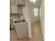 Kitchen view features updated countertops, stainless steel sink, and a view to the back door at 11608 Zimmerman Rd, Port Richey, FL 34668
