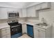 Kitchen features stainless steel appliances, a modern faucet, and updated lighting at 11608 Zimmerman Rd, Port Richey, FL 34668