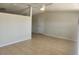 Bright living room features neutral paint, new ceiling fan and tile flooring throughout at 11608 Zimmerman Rd, Port Richey, FL 34668