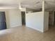 The living room offers a neutral palette, tile flooring and a ceiling fan at 11608 Zimmerman Rd, Port Richey, FL 34668