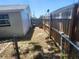 Narrow side yard with wooden fence offering privacy between buildings and gate access at 11608 Zimmerman Rd, Port Richey, FL 34668