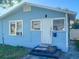Light blue single story house with a white door and steps leading to the entrance at 1776 28Th N Ave, St Petersburg, FL 33713