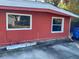 Red single-story house with two windows and a blue recycling bin at 1776 28Th N Ave, St Petersburg, FL 33713