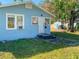 Light blue single story house with a white door, front yard, and a tree at 1776 28Th N Ave, St Petersburg, FL 33713