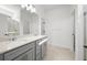 Bathroom featuring double sinks with a vanity, large mirror, and tile flooring at 2327 Candlebrook Path, North Port, FL 34289