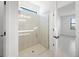 Bathroom shower with frameless glass enclosure and a window at 2327 Candlebrook Path, North Port, FL 34289