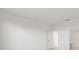 Well-lit bedroom featuring bright white walls and a doorway to the bathroom at 2327 Candlebrook Path, North Port, FL 34289