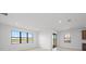 Bright living room with large windows overlooking the scenic backyard pond at 2327 Candlebrook Path, North Port, FL 34289