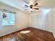 Second bedroom with hardwood floors and a large window at 2553 Forest Run Ct # 150A, Clearwater, FL 33761