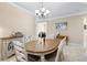 Elegant dining room featuring a wood table and decorative chandelier at 309 Mystic Falls Dr, Apollo Beach, FL 33572