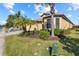Exterior view of charming villa with lush landscaping at 309 Mystic Falls Dr, Apollo Beach, FL 33572