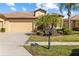 Inviting home exterior featuring a two-car garage and manicured lawn at 309 Mystic Falls Dr, Apollo Beach, FL 33572