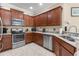 Modern kitchen with stainless steel appliances and wood cabinets at 309 Mystic Falls Dr, Apollo Beach, FL 33572