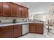 Modern kitchen with stainless steel dishwasher and granite countertops at 309 Mystic Falls Dr, Apollo Beach, FL 33572