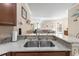 Kitchen features granite countertops, stainless steel sink, and ample wood cabinets at 309 Mystic Falls Dr, Apollo Beach, FL 33572
