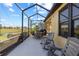 Relaxing screened patio with seating area, overlooking a tranquil water view at 309 Mystic Falls Dr, Apollo Beach, FL 33572