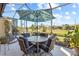 Relaxing screened patio with outdoor seating and canal view at 309 Mystic Falls Dr, Apollo Beach, FL 33572