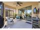 Cozy screened patio with comfortable seating and access to the backyard at 309 Mystic Falls Dr, Apollo Beach, FL 33572
