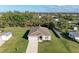 Aerial view of a single-story house with a large backyard and driveway at 3332 Elkcam Blvd, Port Charlotte, FL 33952