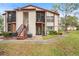 Two-story condo building with red stairs and screened balcony at 3455 Countryside Blvd # 35, Clearwater, FL 33761