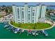 Stunning aerial view of a waterfront condo building with private boat slips and lush landscaping at 400 64Th Ave # 908, St Pete Beach, FL 33706