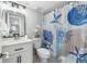 Cozy bathroom featuring vanity and nautical-themed shower curtain at 400 64Th Ave # 908, St Pete Beach, FL 33706