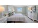 Bedroom with a serene view and white furnishings at 400 64Th Ave # 908, St Pete Beach, FL 33706