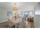 Elegant dining room and living space with luxury furniture, wood floors, and balcony at 400 64Th Ave # 908, St Pete Beach, FL 33706