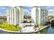 Beautiful condominium complex featuring a pool, manicured lawn, and waterfront views at 400 64Th Ave # 908, St Pete Beach, FL 33706