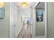 Bright hallway featuring wood-look floors and doors leading to the living area at 400 64Th Ave # 908, St Pete Beach, FL 33706