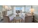 Bright living room with luxury furniture, wood floors, and balcony with water views at 400 64Th Ave # 908, St Pete Beach, FL 33706