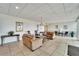 Comfortable lobby area with couches, chairs, tables, and neutral tile flooring at 400 64Th Ave # 908, St Pete Beach, FL 33706