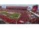 Aerial view of a packed football stadium with an American flag spread across the field at 400 64Th Ave # 908, St Pete Beach, FL 33706