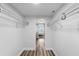 Spacious walk-in closet with ample shelving and a glimpse into the bright bedroom at 400 64Th Ave # 908, St Pete Beach, FL 33706