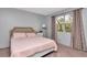 Spacious bedroom with a queen-size bed and ample natural light at 5004 Terrace Palms Cir # 201, Tampa, FL 33617