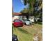 Quaint house with a grassy front yard and two parked cars at 8218 N 18Th St, Tampa, FL 33604