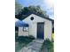 Detached guest house with a black door and small yard at 8218 N 18Th St, Tampa, FL 33604